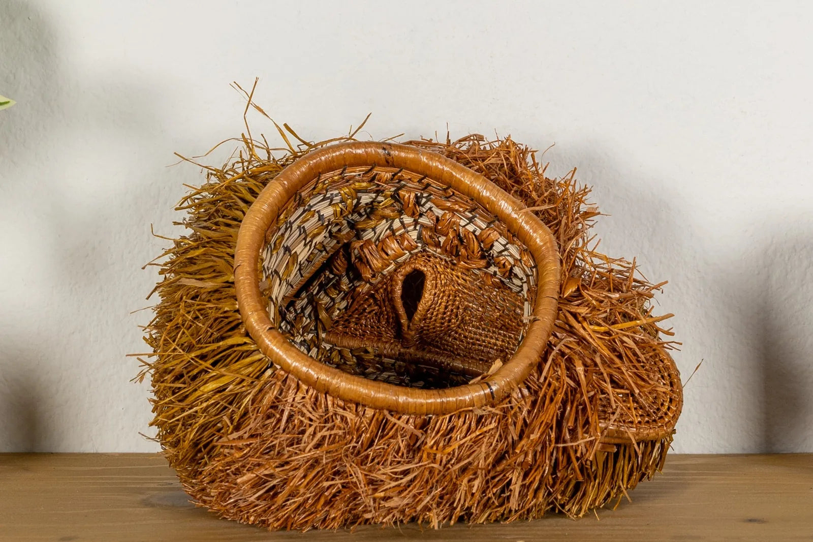 Handwoven Brown Labradoodle dog mask featuring natural fibers in warm brown tones, showcasing intricate weaving patterns.