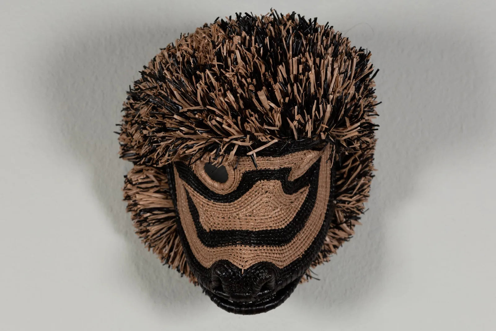 Handwoven brown Poodle dog mask featuring intricate patterns and natural colors, perfect for wall decor.