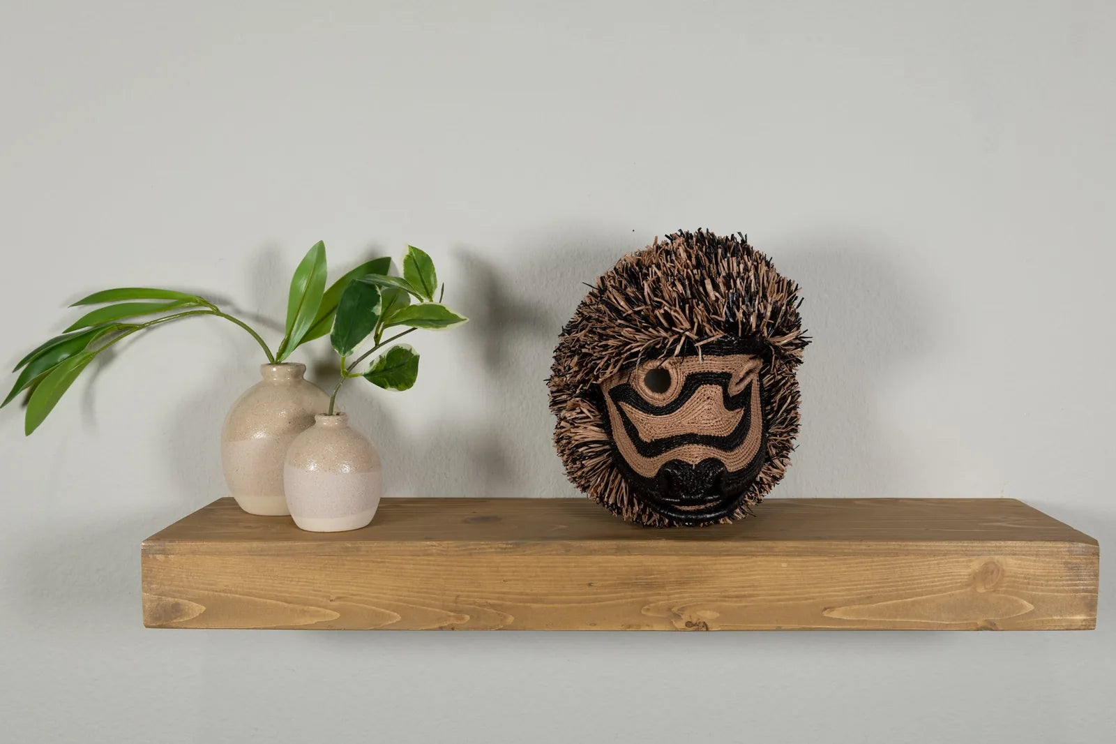 Handwoven Brown Poodle Dog Mask features intricate patterns and natural hues, perfect for unique wall decor.