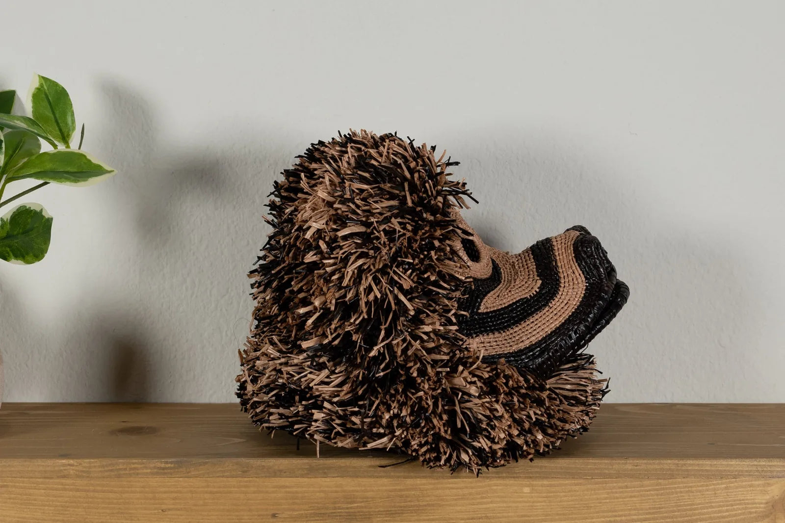 Handwoven brown Poodle dog mask featuring textured natural fibers and intricate patterns, ideal for wall decor.