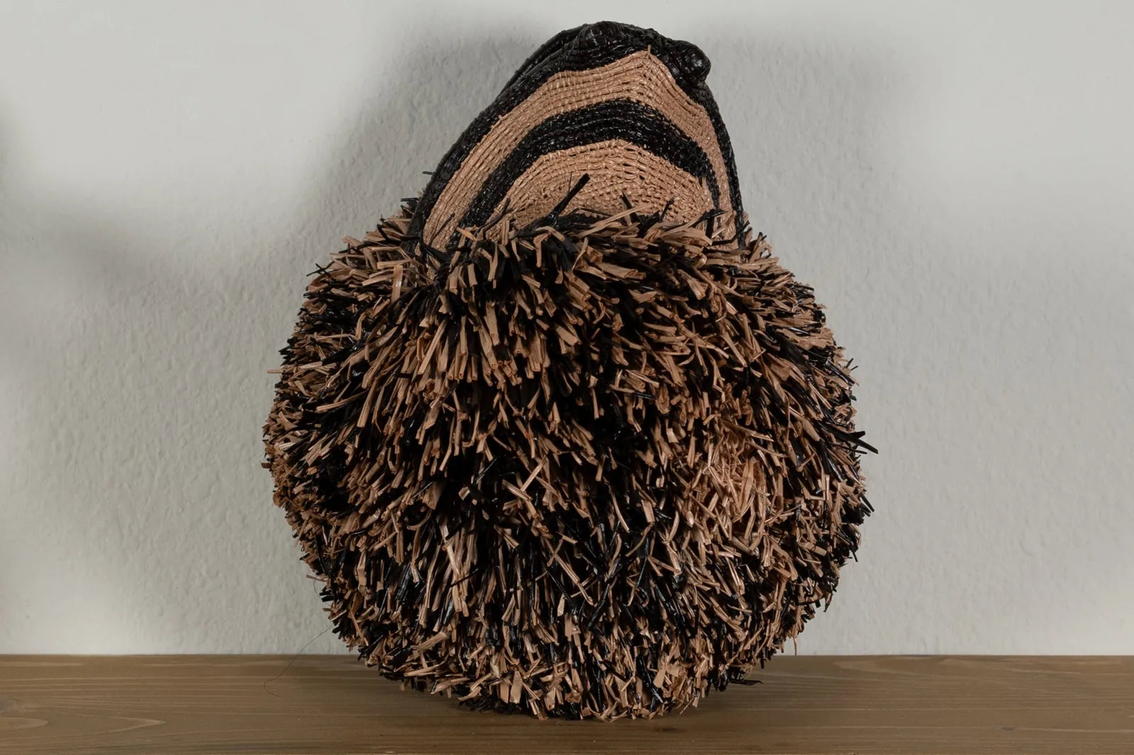 Handwoven brown Poodle dog mask featuring natural hues and intricate textures, perfect for unique wall decor.