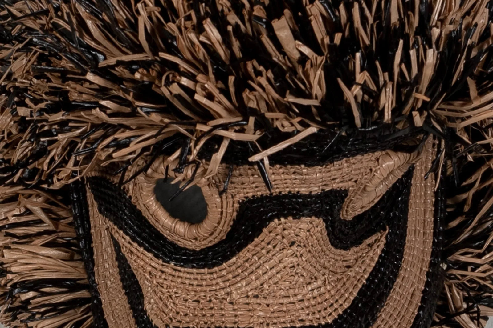 Handwoven brown Poodle dog mask featuring natural fibers, intricate patterns, and black detailing, ideal for wall decor.