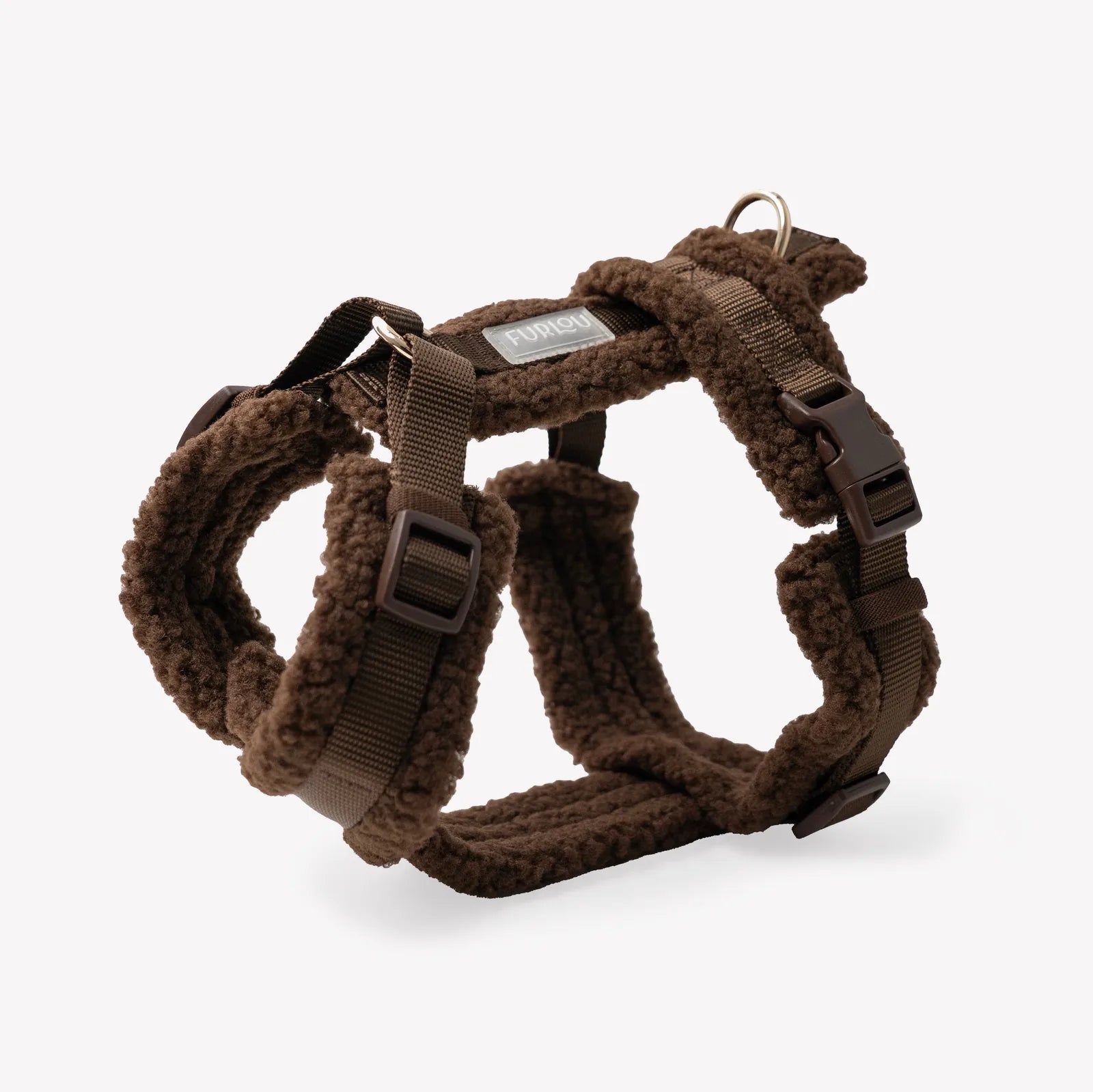 Brown sherpa dog harness with adjustable straps and gold details, designed for comfort during cool walks.