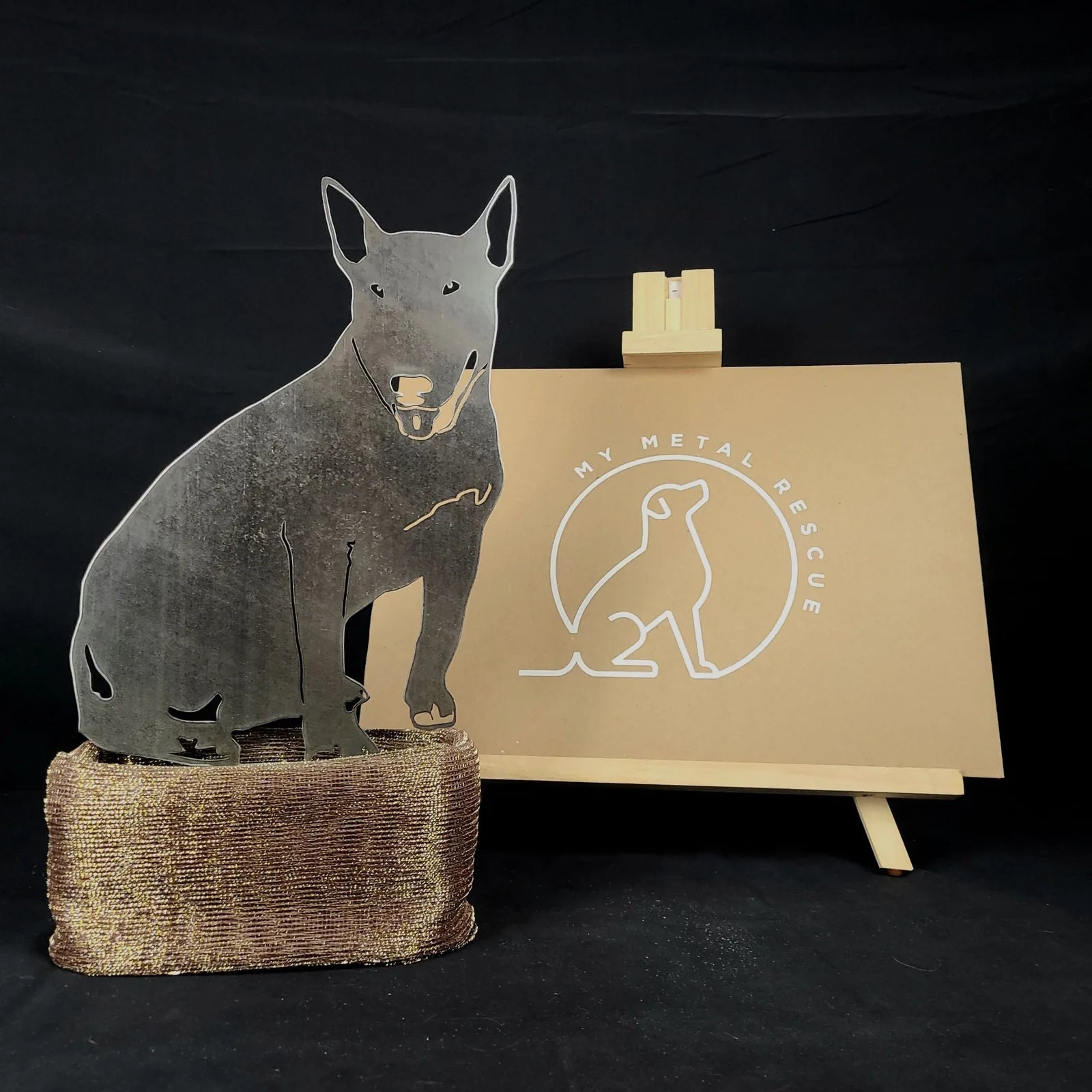 Bull Terrier metal silhouette in Corten steel, featuring a rustic design, displayed on a textured base.