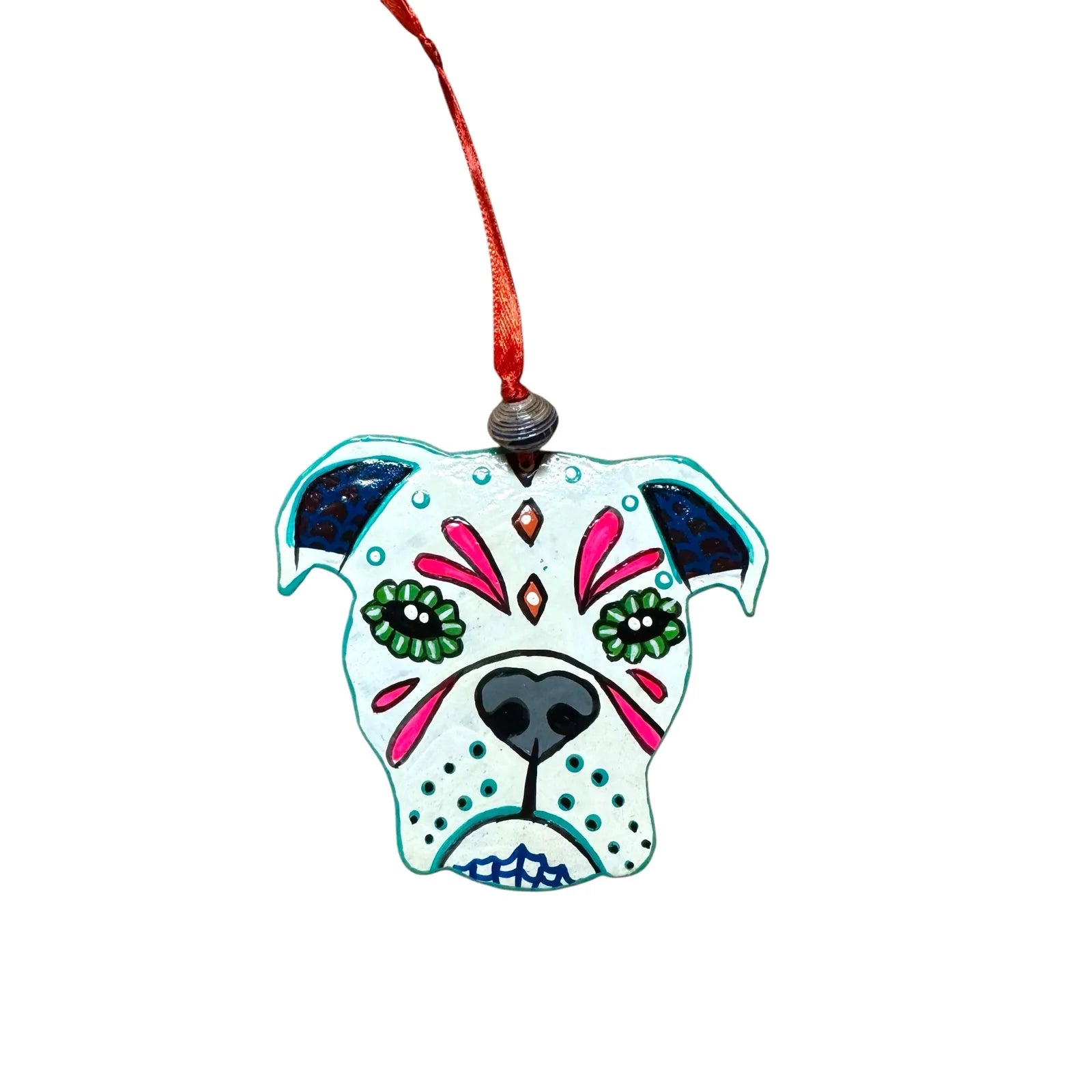 Colorful metal Bulldog ornament with intricate designs, featuring green eyes and a red ribbon for hanging.
