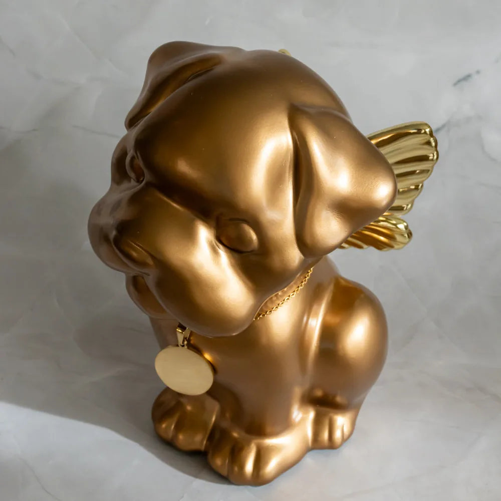 Handcrafted gold dog urn featuring wings, with a round tag, honoring Bully breeds in a respectful design.