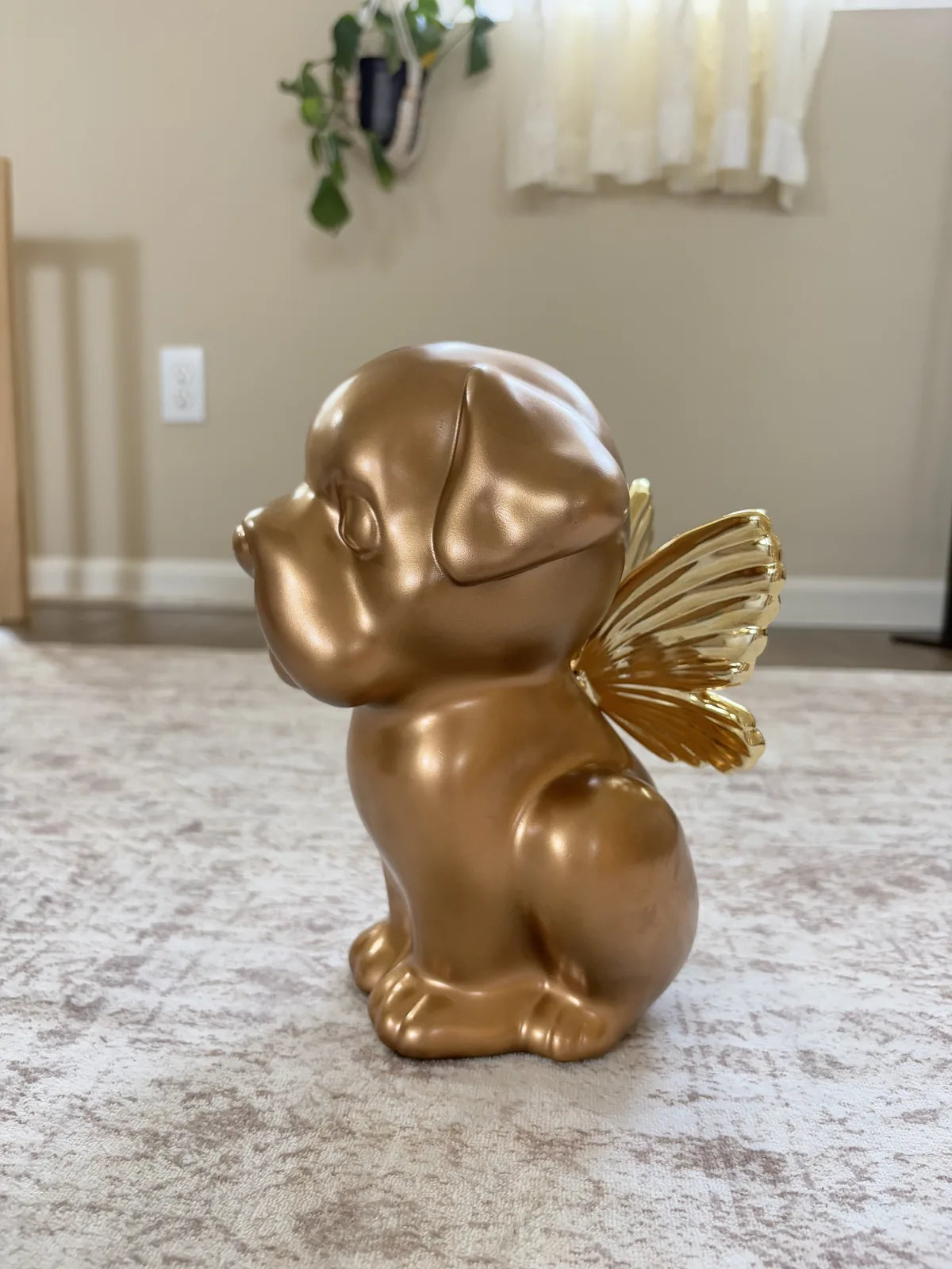 Handcrafted gold dog urn shaped like a Bully breed puppy with decorative wings, perfect for pet memorials.