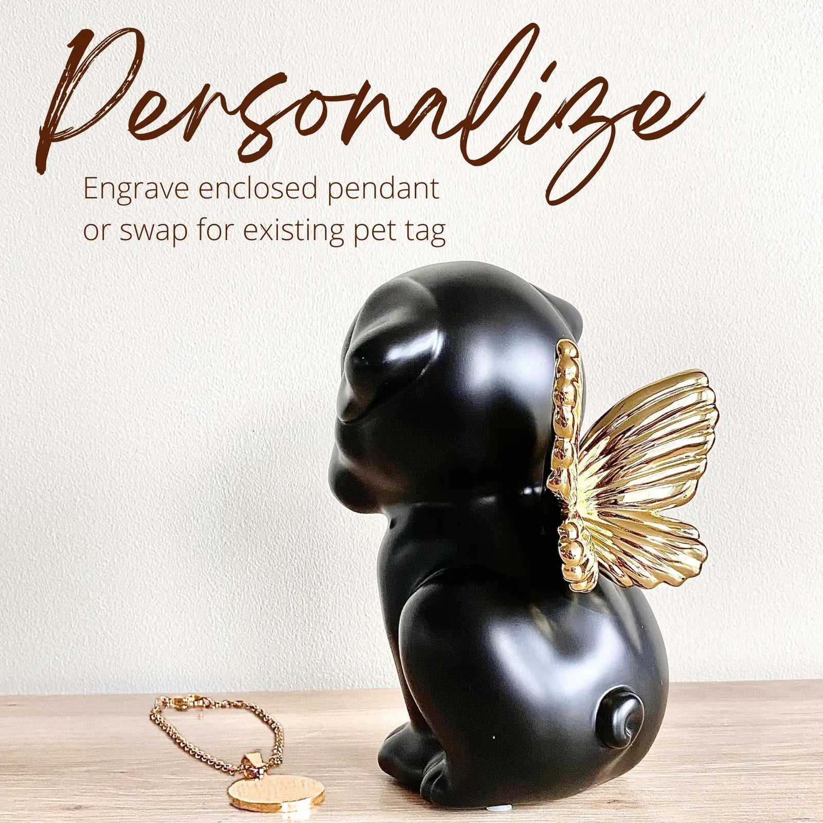 Handcrafted black dog urn with gold wings, featuring an enclosure for personalization, ideal for pet memorial.