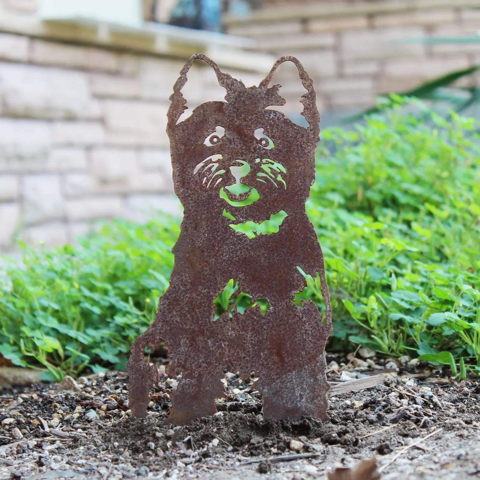 Cairn Terrier metal silhouette made from weathering Corten steel, showcasing intricate cutout details and a rustic patina.