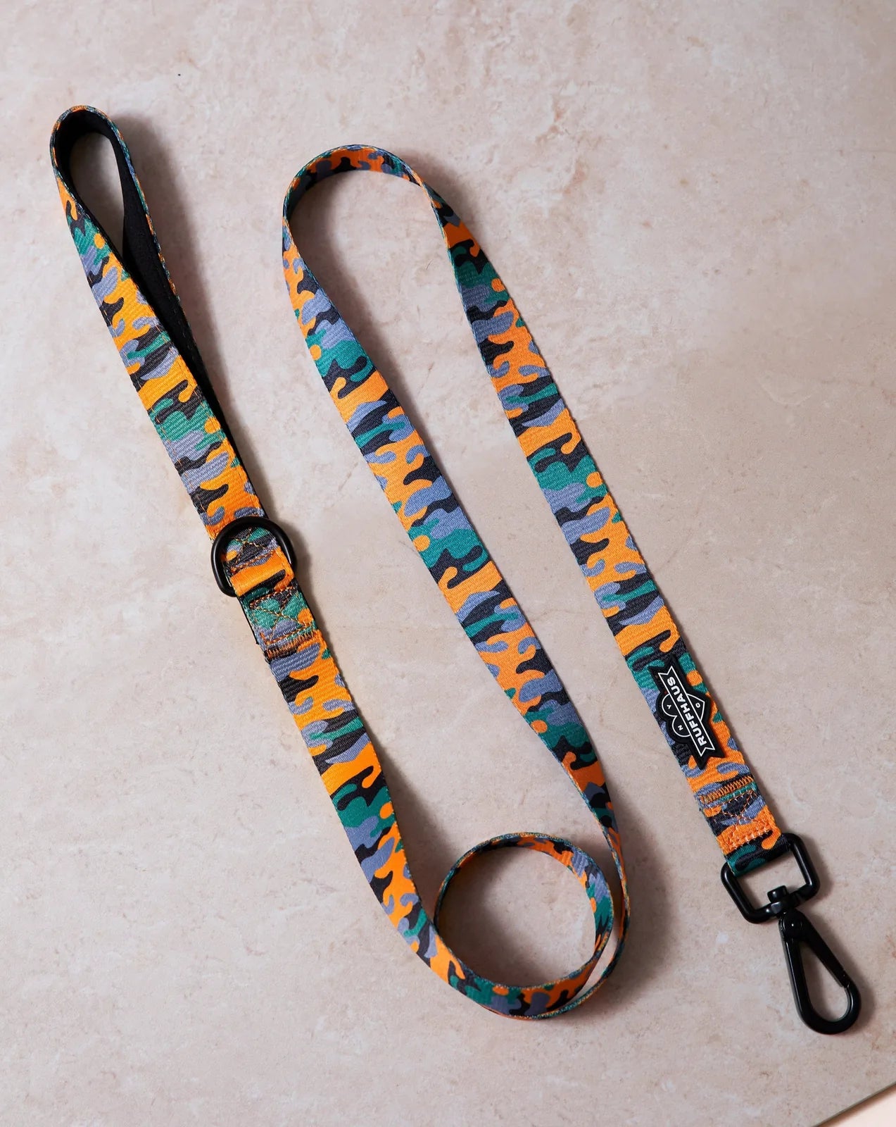 Camo QT Orange Dog Leash by RUFFHAUS NYC featuring a vibrant camo pattern in orange, green, gray, and black on durable mat...