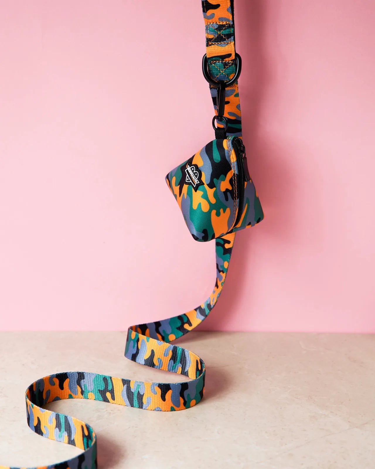Camo QT Orange dog leash with vibrant orange, green, and gray patterns, featuring a neoprene-lined handle and clasp.