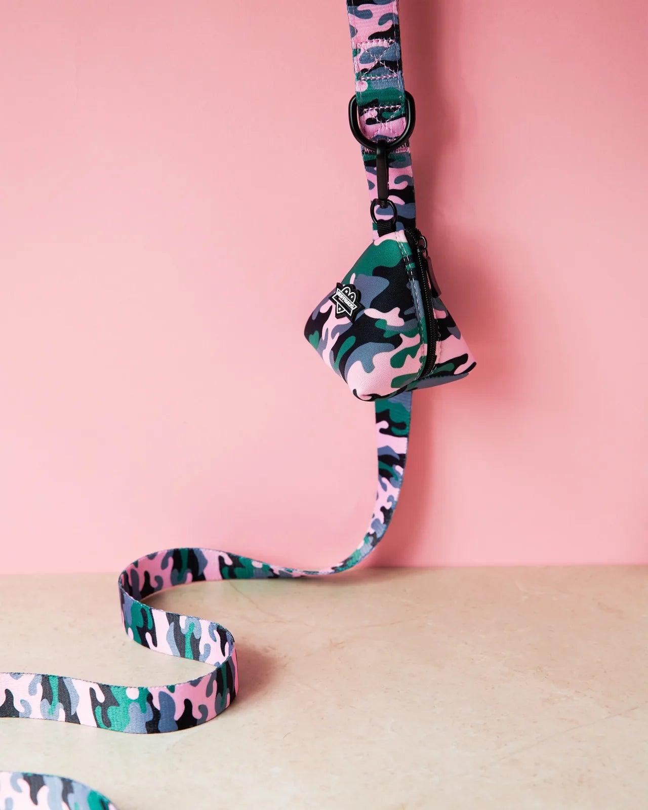 Pink camouflage dog leash by RUFFHAUS NYC with a neoprene-lined handle, displayed against a pink background.