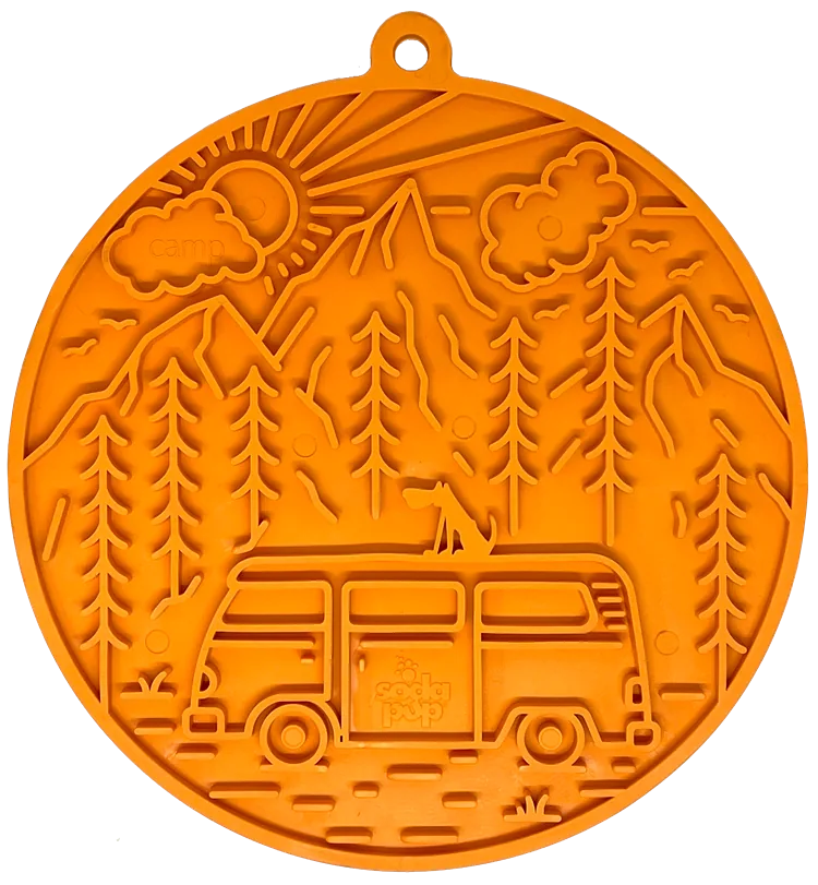 Retro orange lick mat featuring a camper van design with mountains, trees, and a sun for dog enrichment.