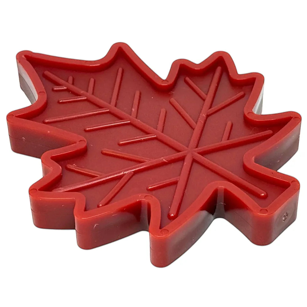 Red Canadian maple leaf-shaped nylon dog chew toy, designed for durability and treat enrichment.