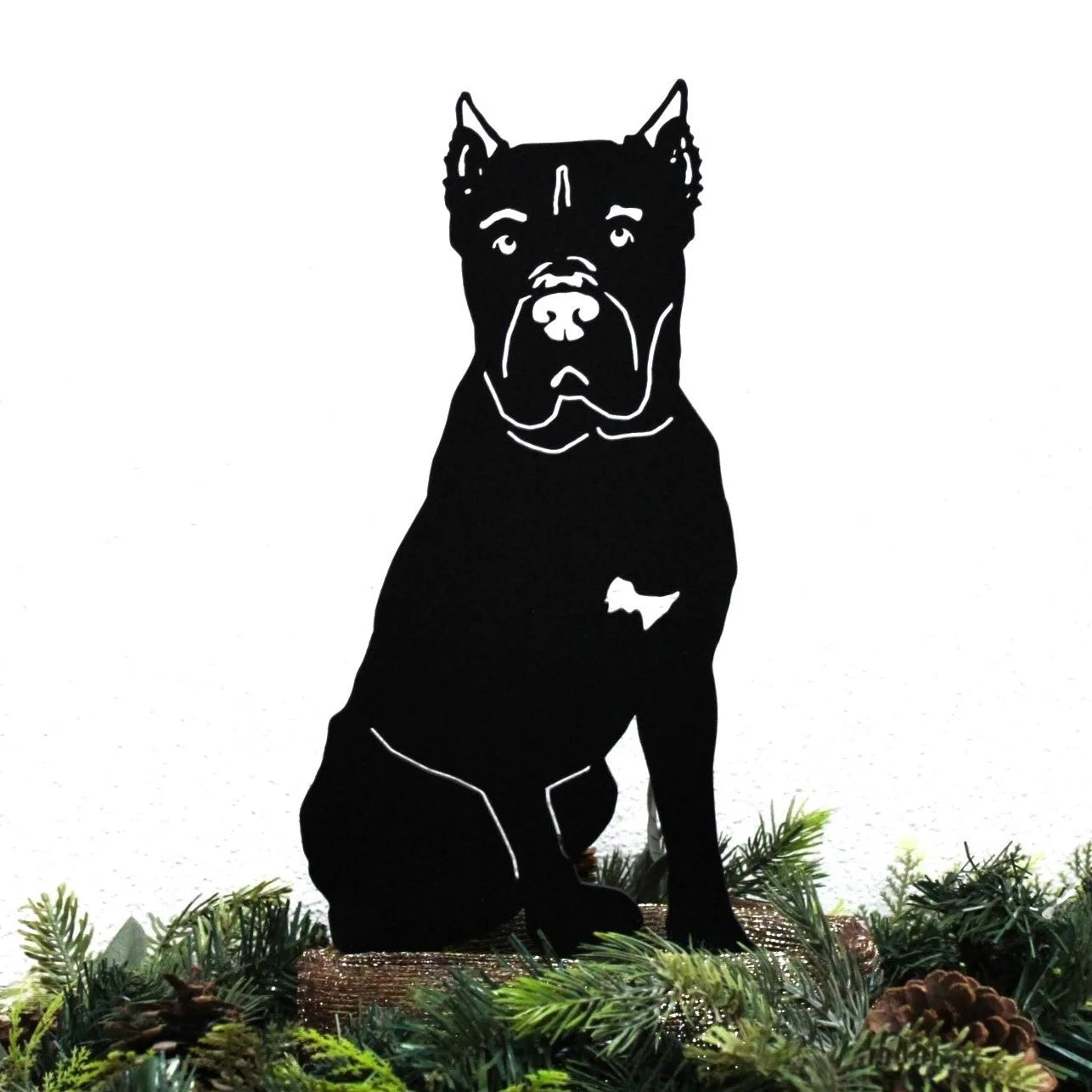 Cane Corso metal silhouette in matte black, seated, showcasing detailed features, surrounded by greenery.