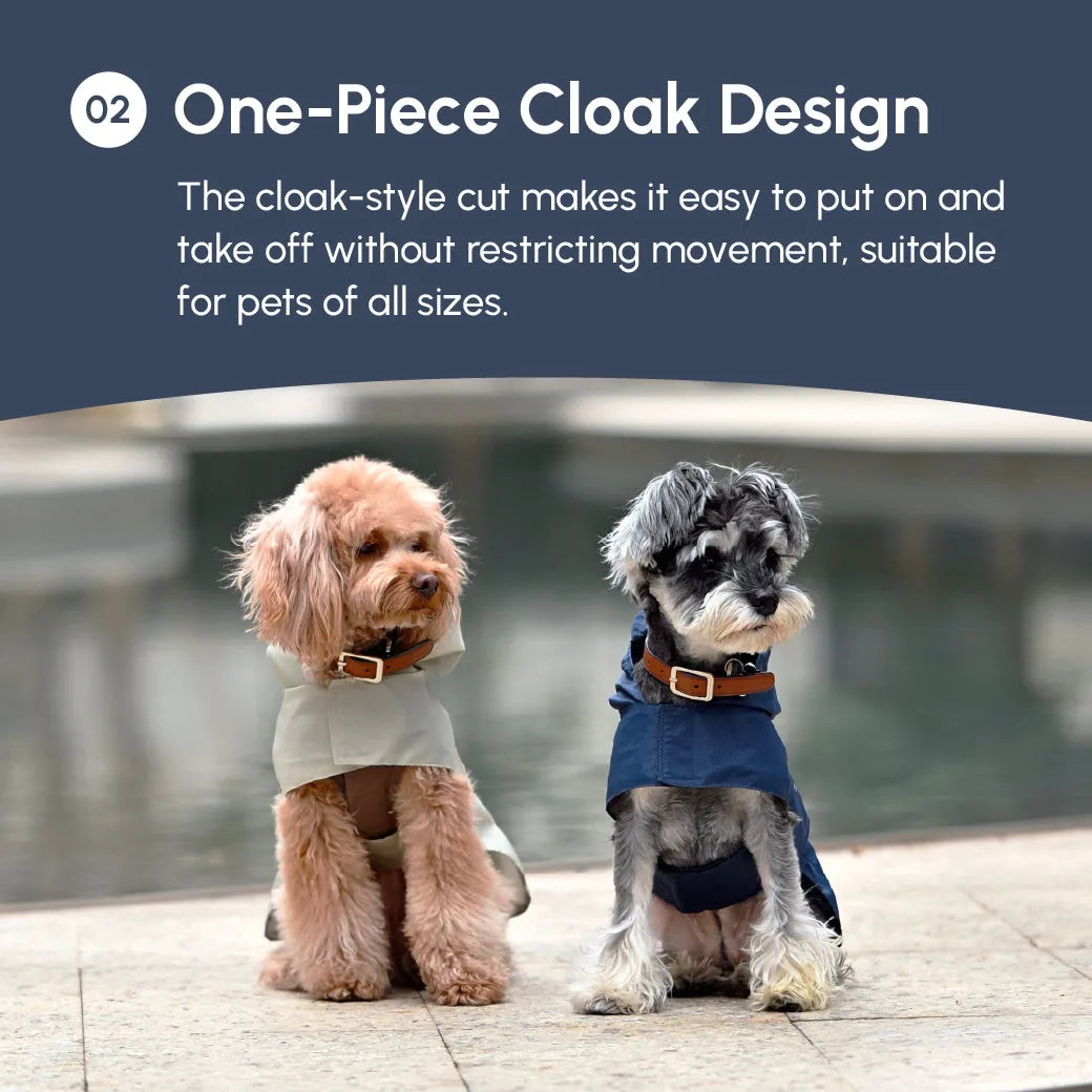 Two dogs wearing stylish cloak-style raincoats; one in light beige, the other in blue, showcasing comfort and mobility.