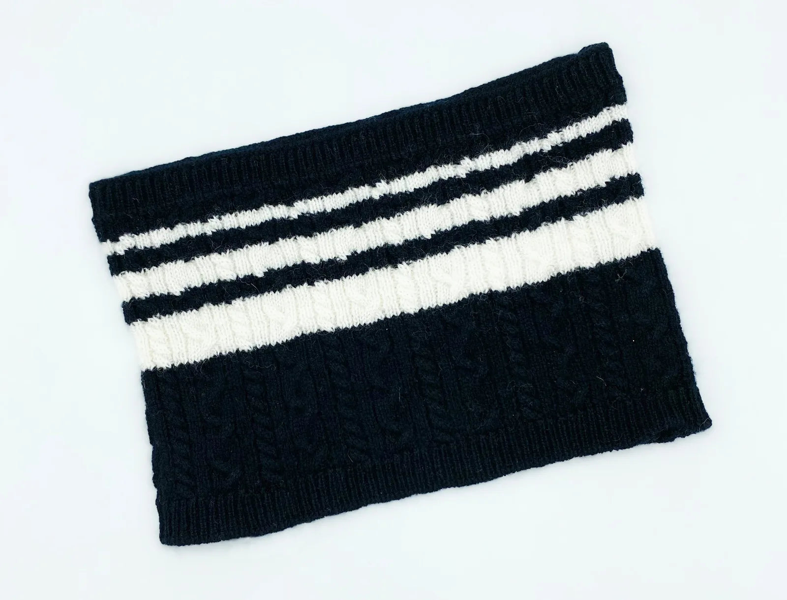 Cozy black and white cable-knit bandana for pets, made from a soft cashmere blend. Perfect for stylish matching.
