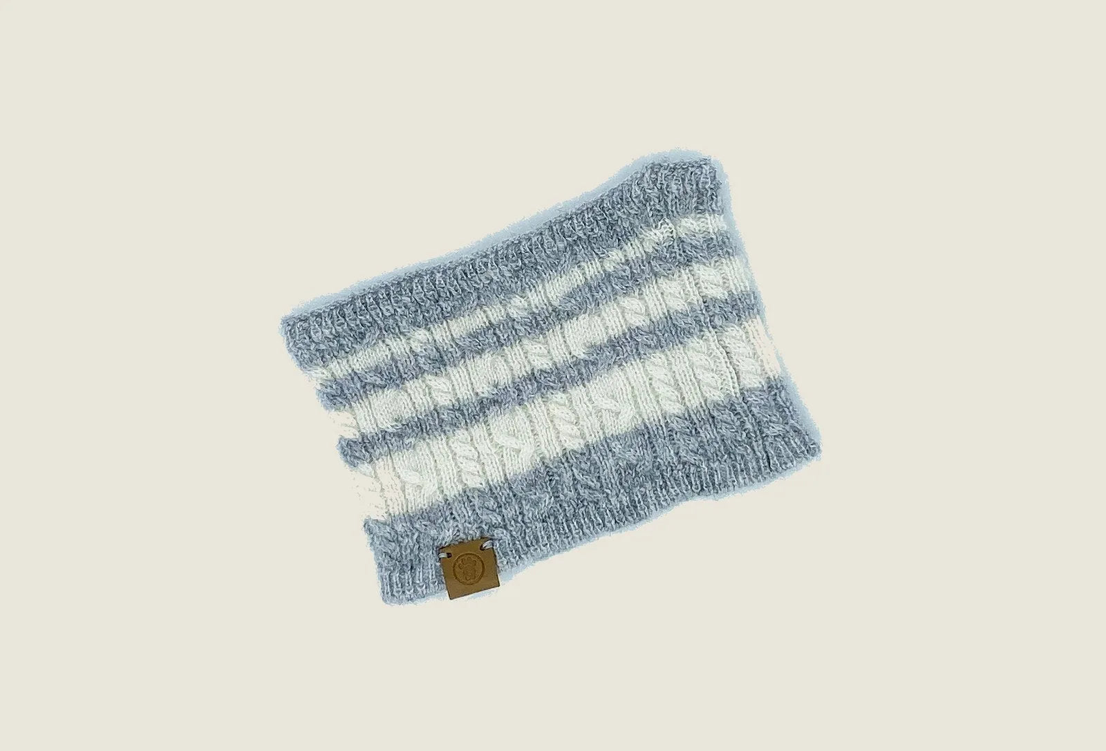 Cashmere blend pet scarf in heather grey with white stripes, featuring a textured knit and a branded tag.