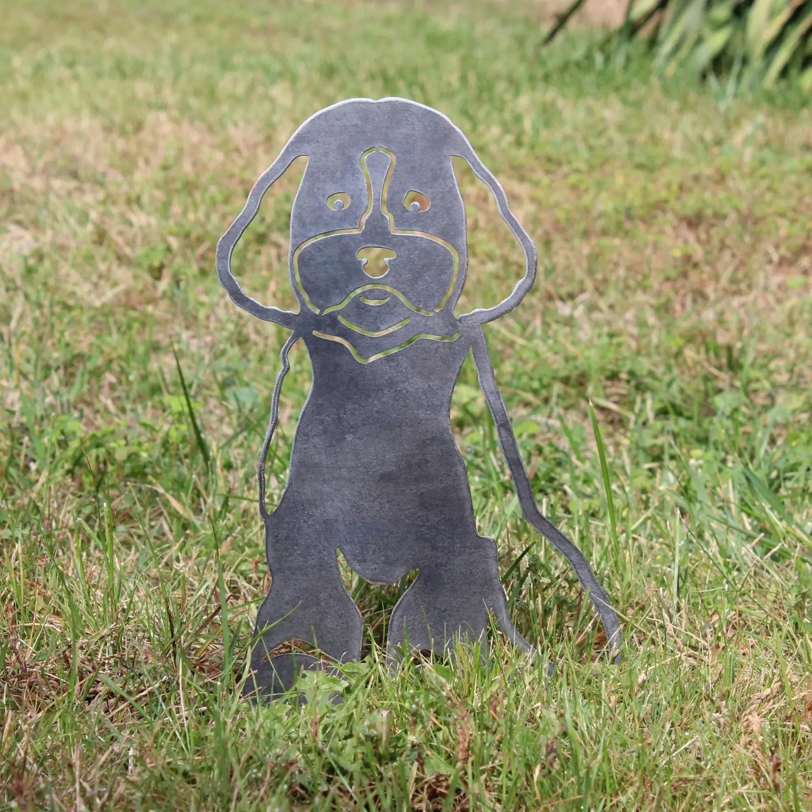 Cavapoo metal silhouette in weathered steel, standing on grass, showcasing intricate cut-out design details.