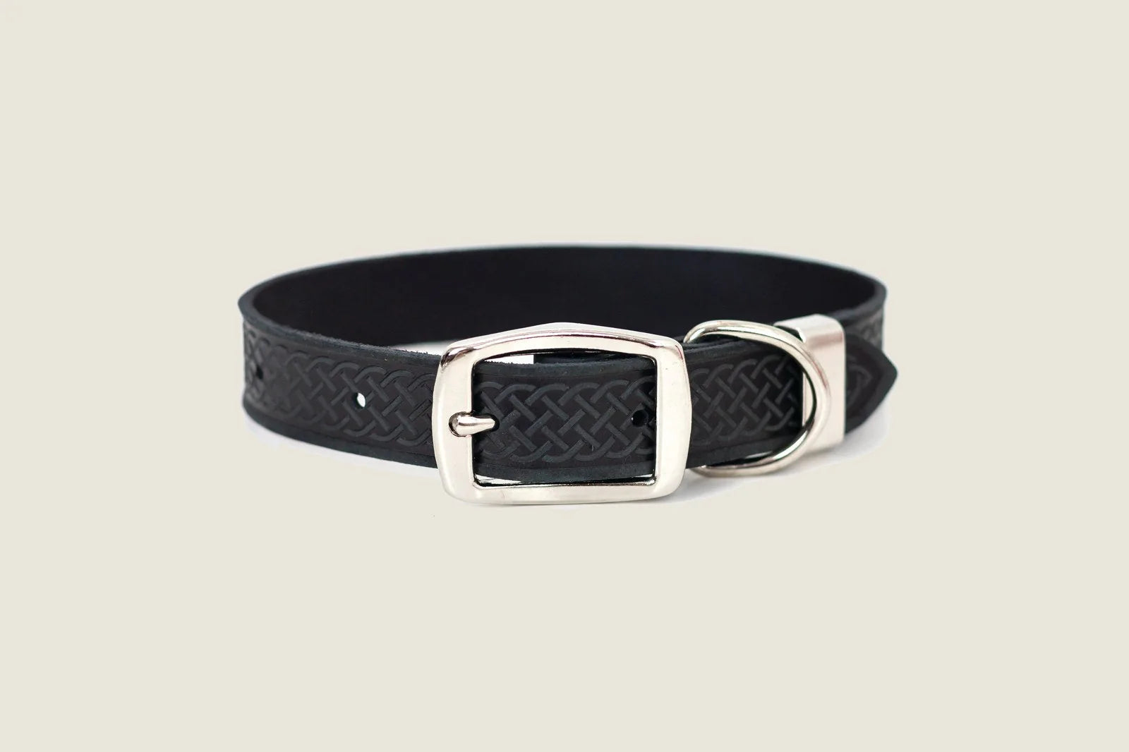 Black leather dog collar featuring a Celtic design, with a silver double-sided buckle and extra metal loop.