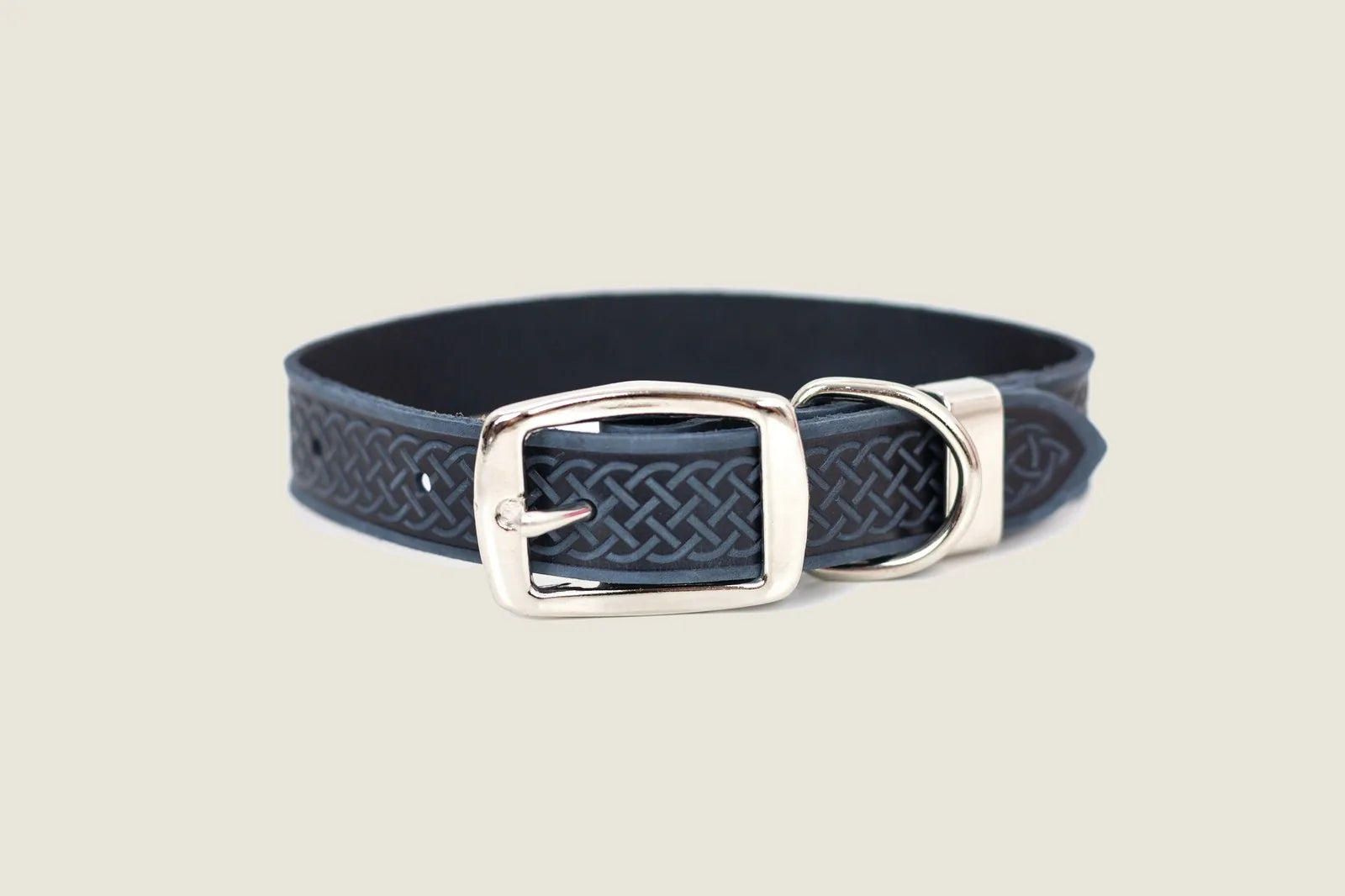 Navy leather dog collar with Celtic design, featuring a double-sided metal buckle and extra loop for secure fit.