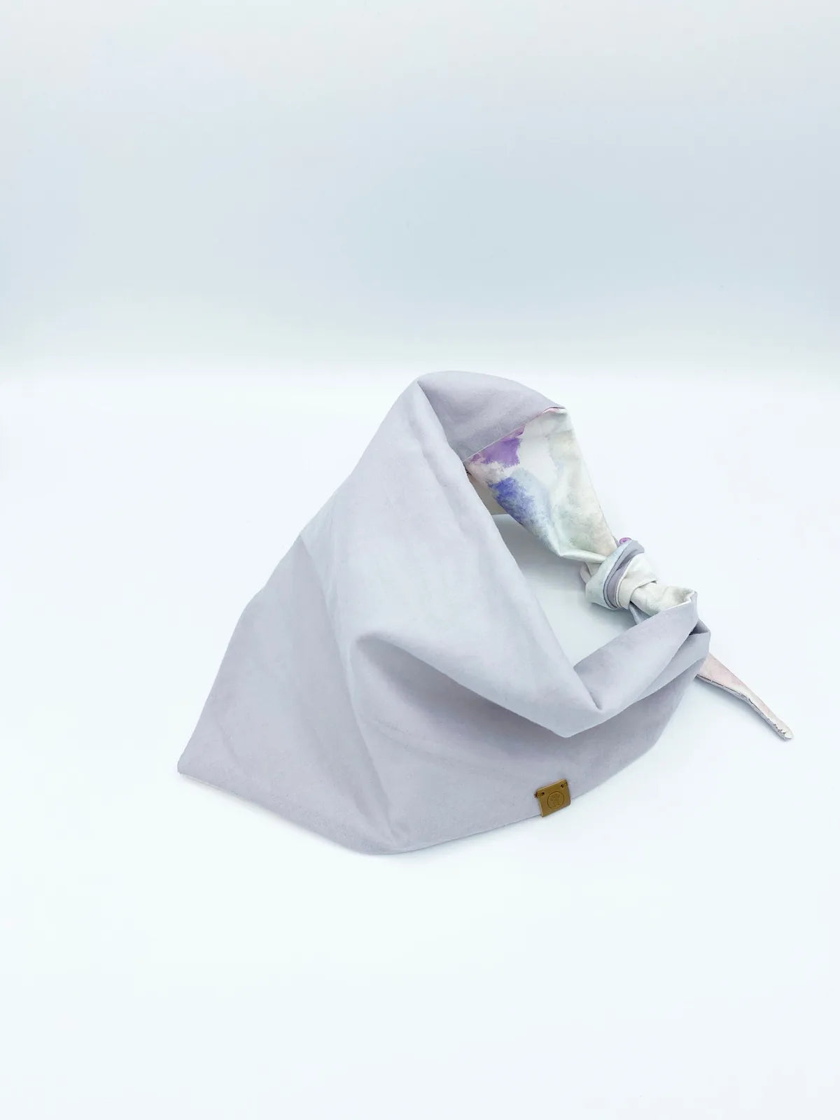 Reversible dog bandana featuring a lilac solid side and a pink tie-dye print, made of soft, breathable cotton.