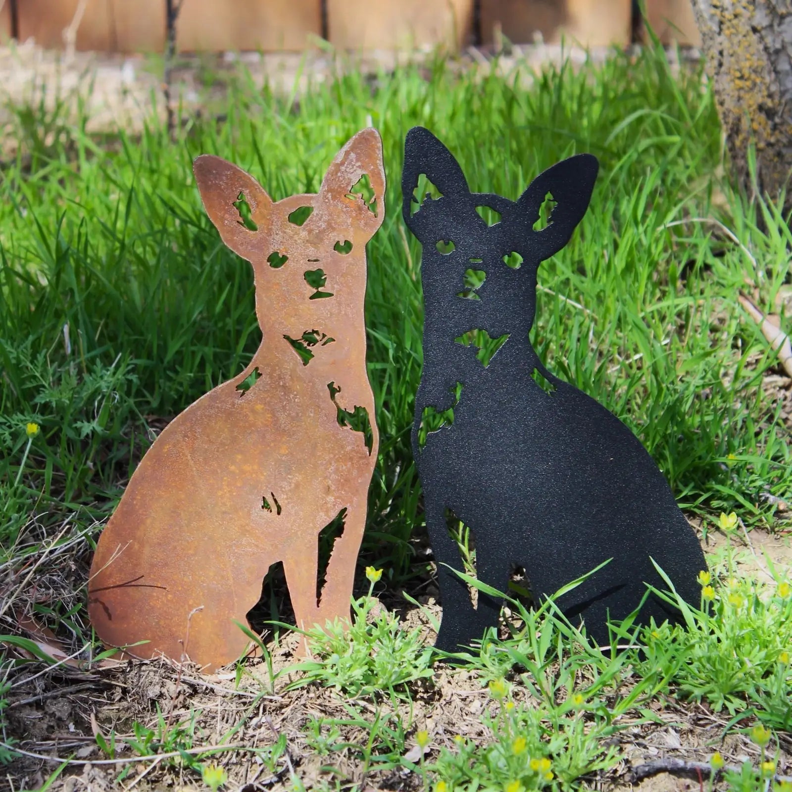 Chihuahua metal wall art in Corten steel and black finish, set against green grass and garden, showcasing unique silhouettes.