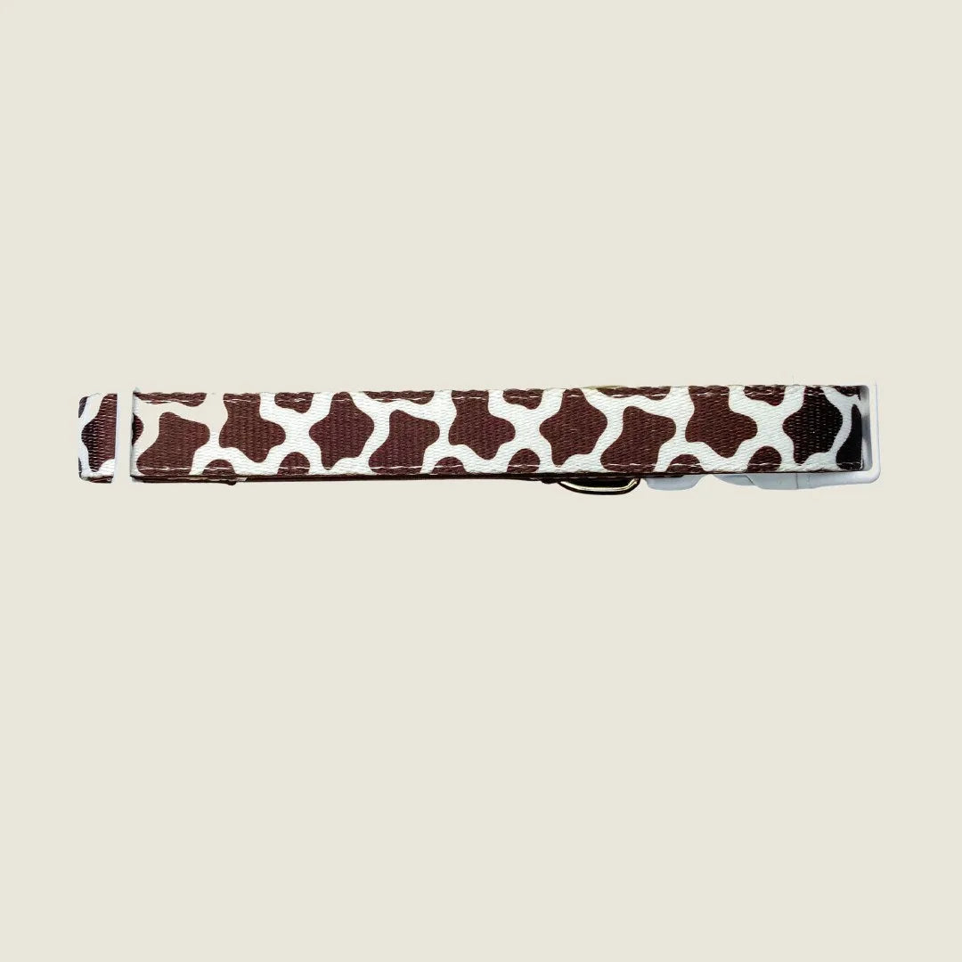 Adjustable Chocolate Cow Collar featuring a playful brown and white cow print pattern on durable polyester webbing.