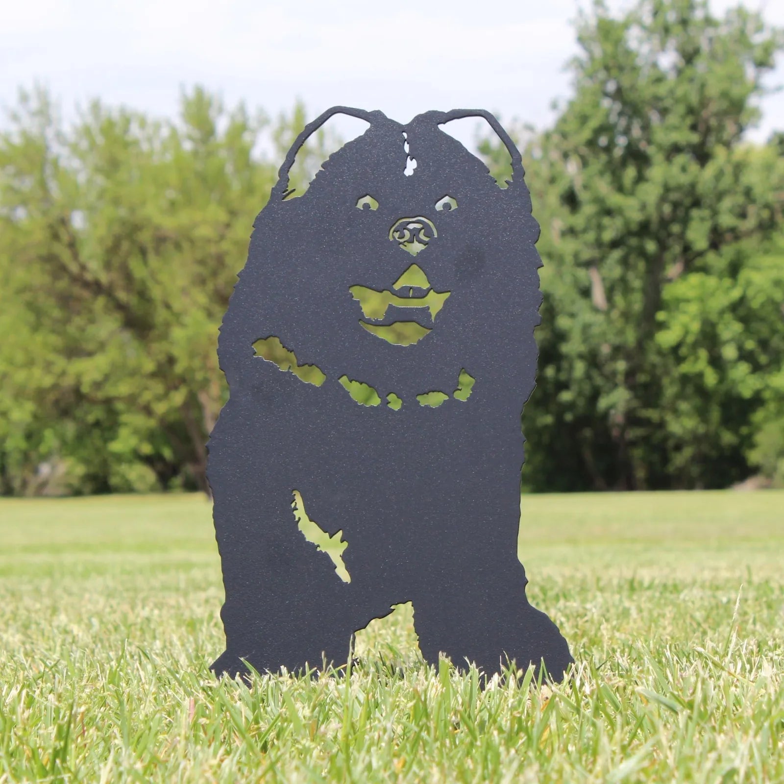 Chow Chow metal silhouette in matte black standing on grass, ideal for outdoor dog decor.