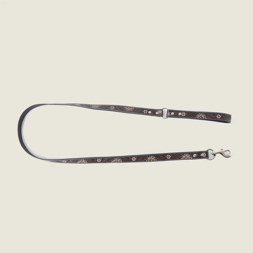 Black leather dog leash with floral embossing and metallic accents, featuring a braided border and durable hardware.