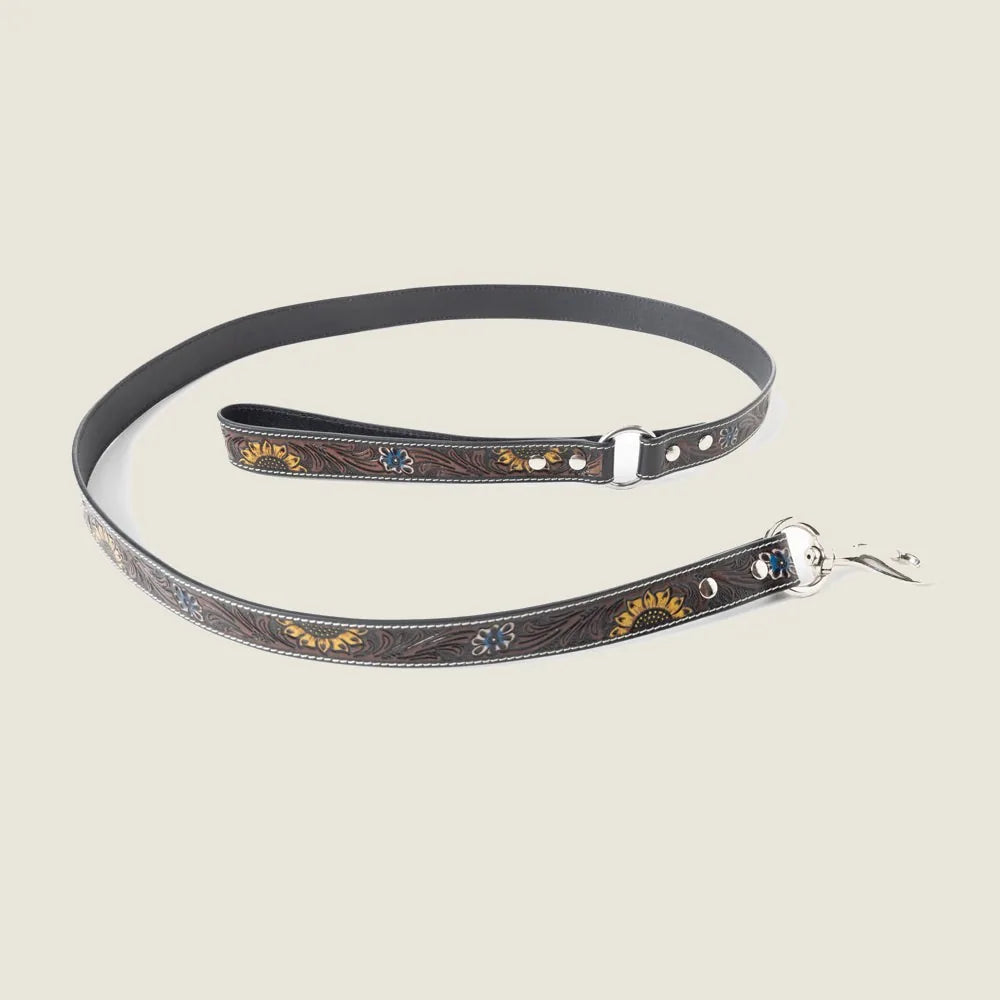 Hand-tooled dark brown leather dog leash featuring floral embossing and a braided border for durability and comfort.