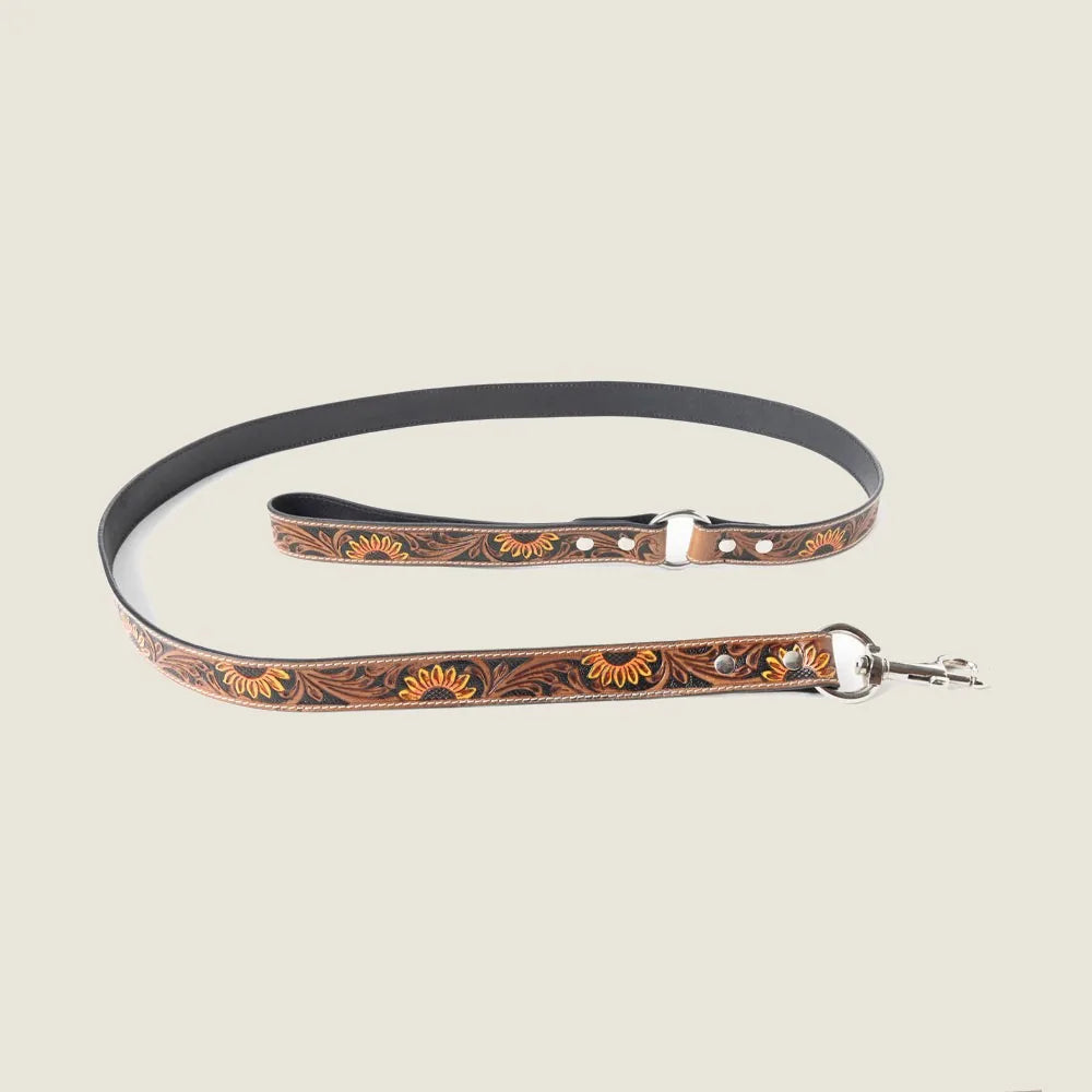 Light brown leather dog leash featuring floral embossing, gold and silver accents, and a braided border.