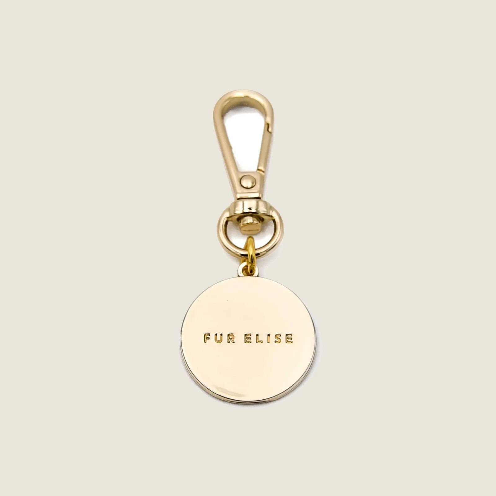 Light gold charm with "FUR ELISE" engraving and a lobster claw clasp, ideal for attaching to dog accessories.