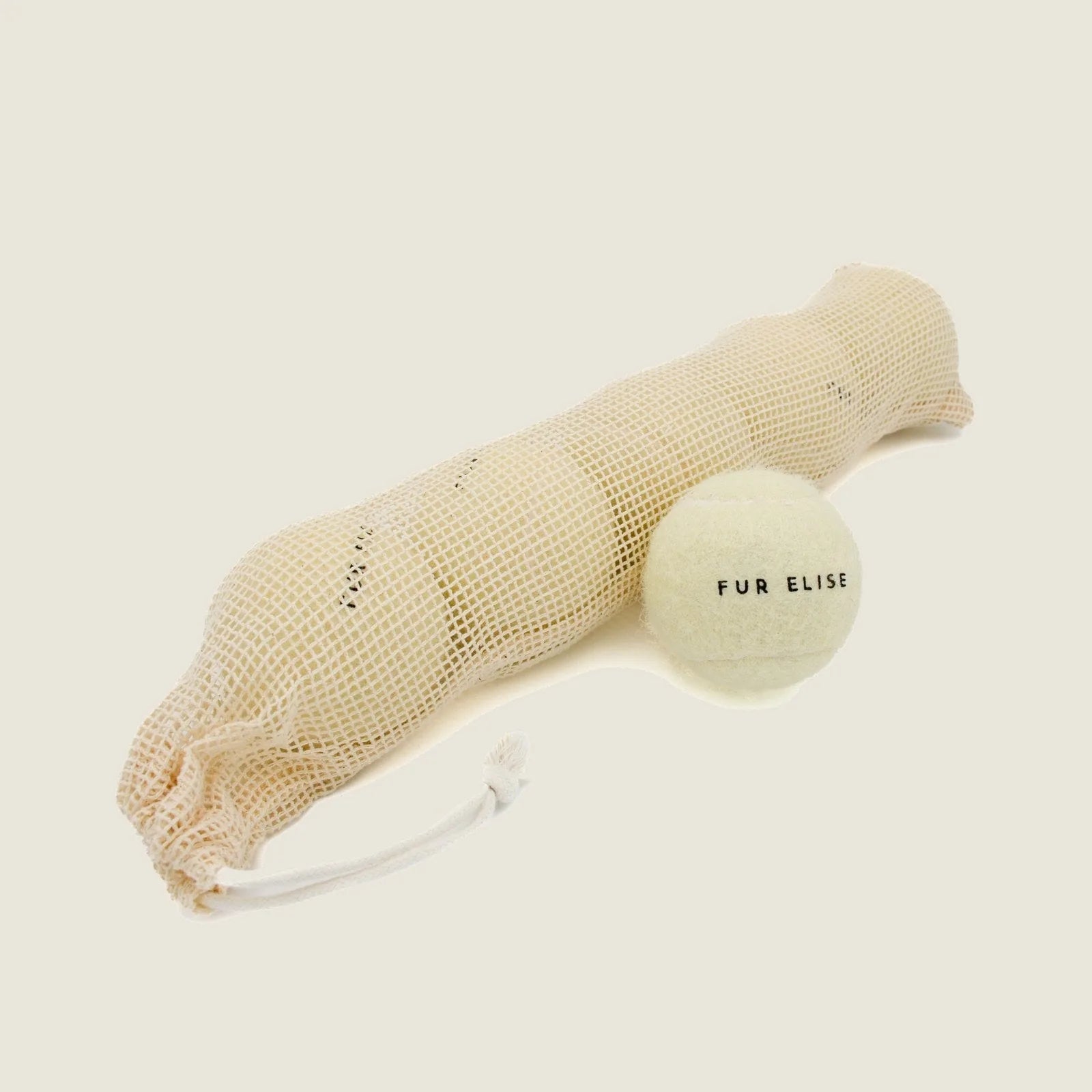 Set of five classic tennis balls in a mesh pouch, designed for durable dog play, featuring a soft felt exterior.