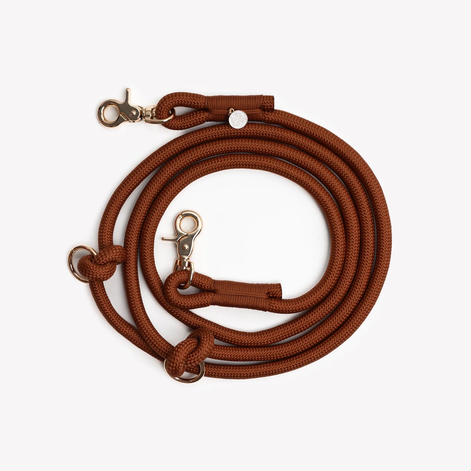 Braided hands-free leash in a rich clay color, featuring gold clips and loops for versatile attachment.