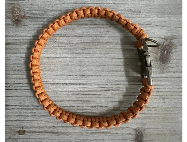 Handmade Cobra Braid dog collar in vibrant orange nylon paracord, featuring a side release buckle and sturdy attachment D-...