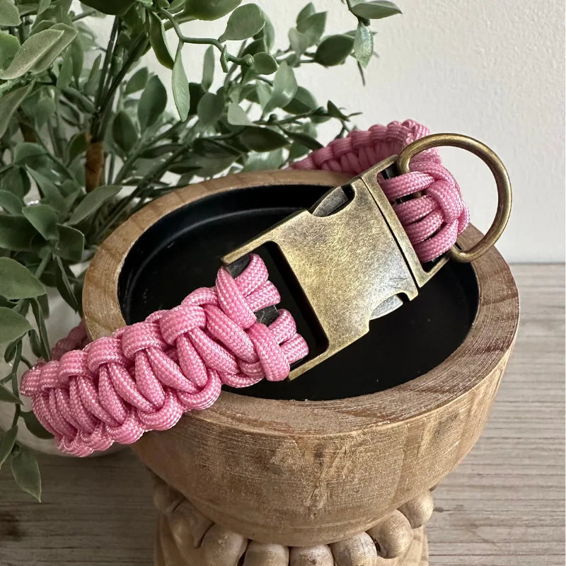 Handmade pink and white striped cobra braid dog collar with a brass buckle and sturdy D-ring for leash attachment.