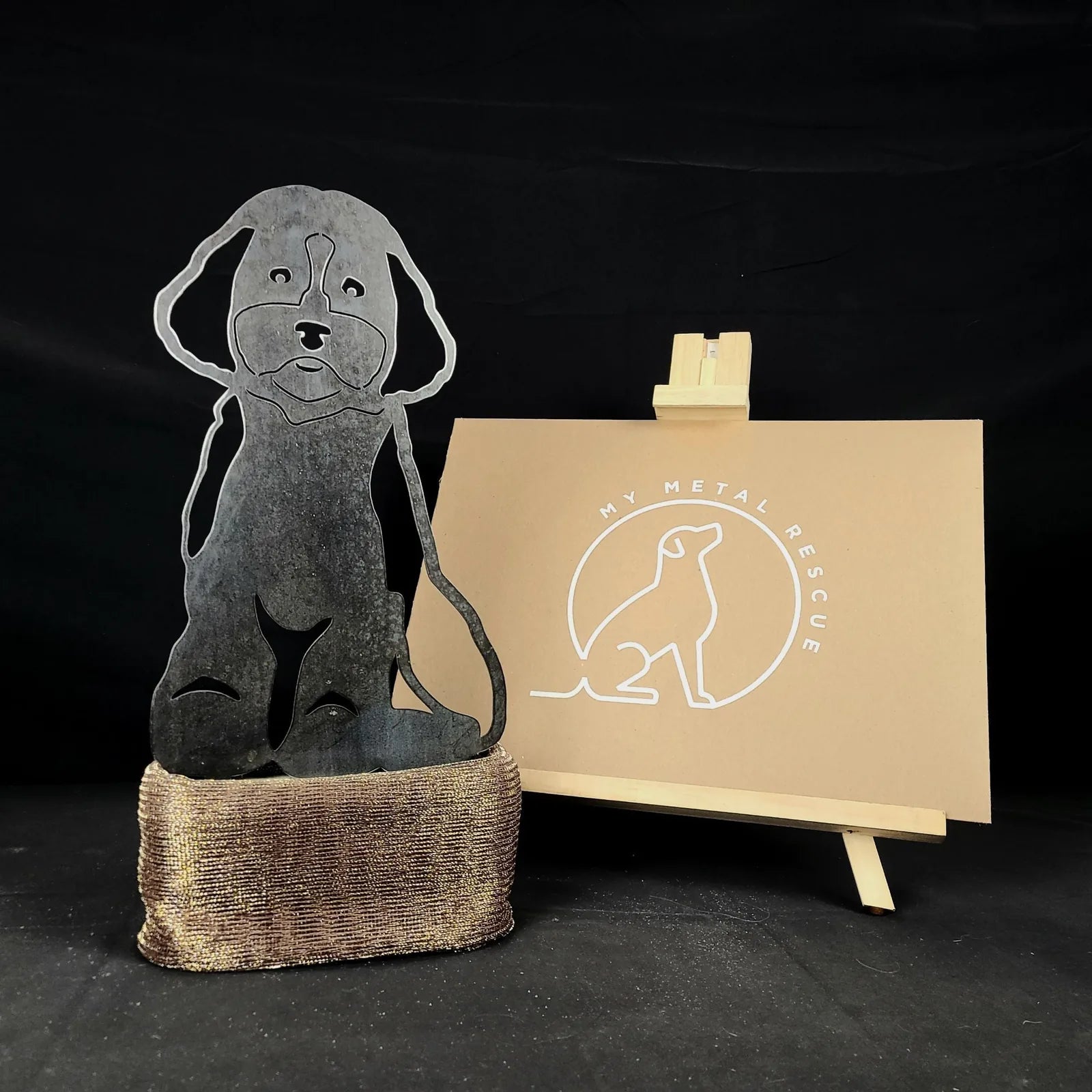 Cockapoo metal silhouette in Corten steel, showcasing a playful design with a textured finish on a decorative base.
