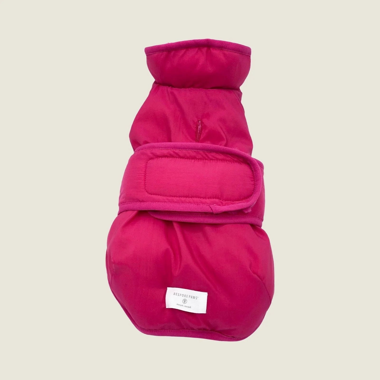 Reversible hot pink faux fur dog vest with adjustable straps, designed for comfort and style during cooler days.