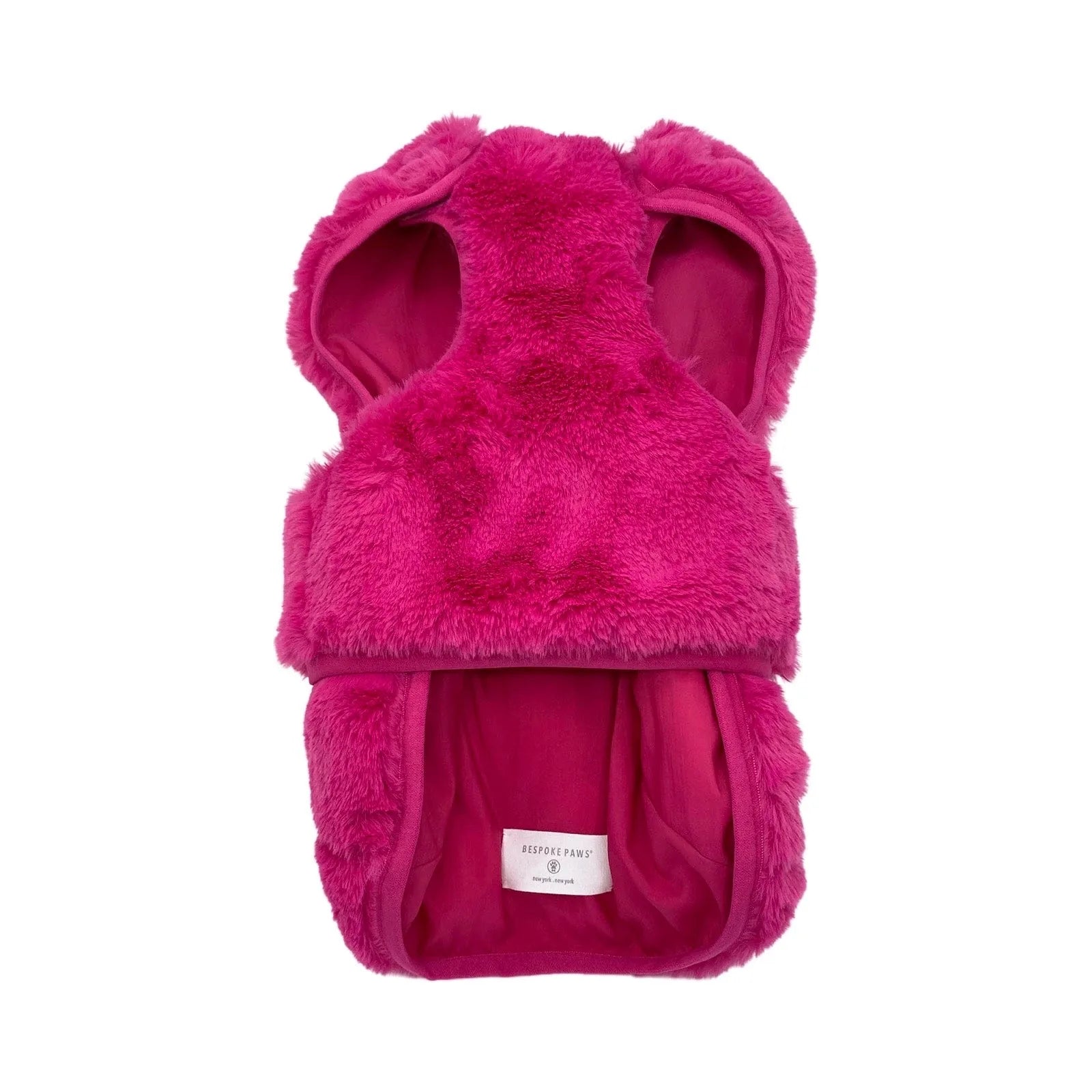 Reversible hot pink faux fur vest for dogs, featuring adjustable straps for a secure fit, by BESPOKE PAWS.