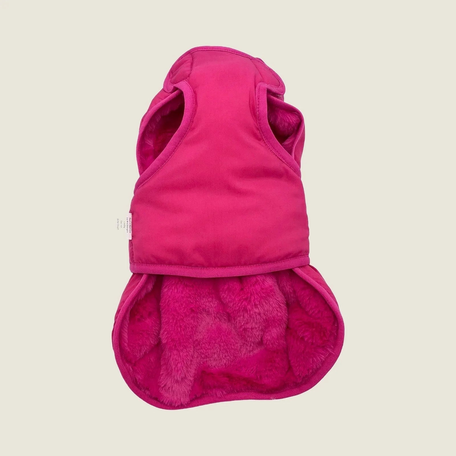 Reversible hot pink faux fur vest for dogs, featuring a cozy design and soft plush lining by BESPOKE PAWS.