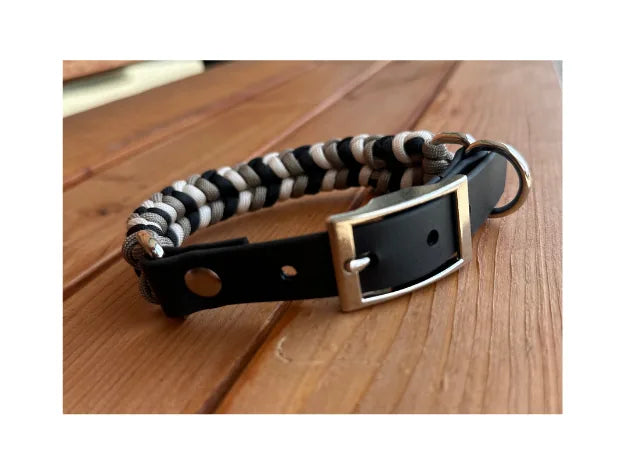 Hand-braided dog collar in black, tan, and cream with nickel plated hardware and adjustable fit for stylish comfort.
