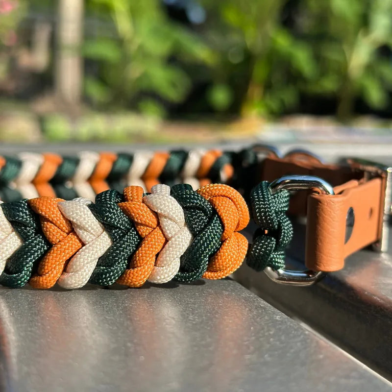 Handmade braided dog collar in hunter green, cream, and mustard yellow with adjustable BioThane® strap and D-ring.