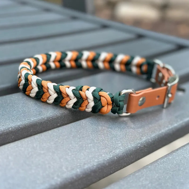 Handmade dog collar in hunter green, mustard yellow, and cream braided design, featuring a leather strap and sturdy D-ring.