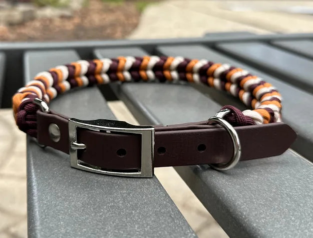 Handmade braided dog collar in mustard yellow, burgundy, and cream, featuring a dark brown adjustable strap with buckle.