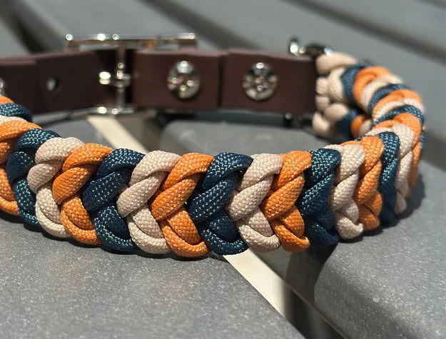 Hand-braided dog collar in mustard, navy, and light tan, featured with a dark brown adjustable strap and nickel-plated buc...