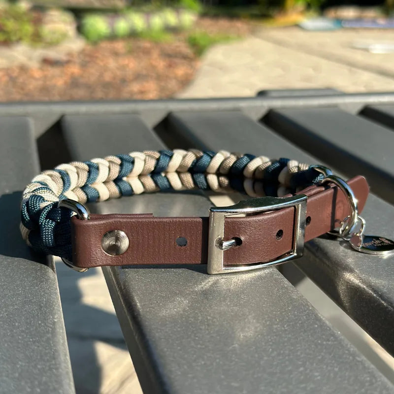 Hand-braided dog collar in navy, tan, and cream with a dark brown adjustable strap and nickel plated buckle.