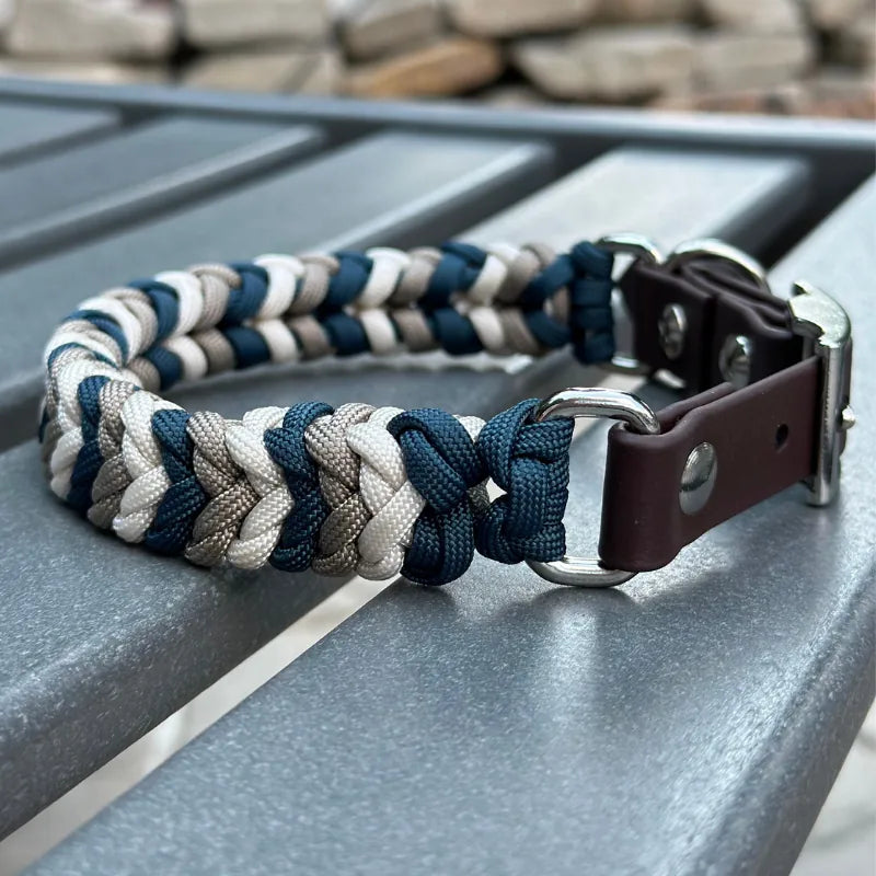 Hand-braided dog collar in navy, tan, and cream with a dark brown strap and nickel plated buckle for durability.