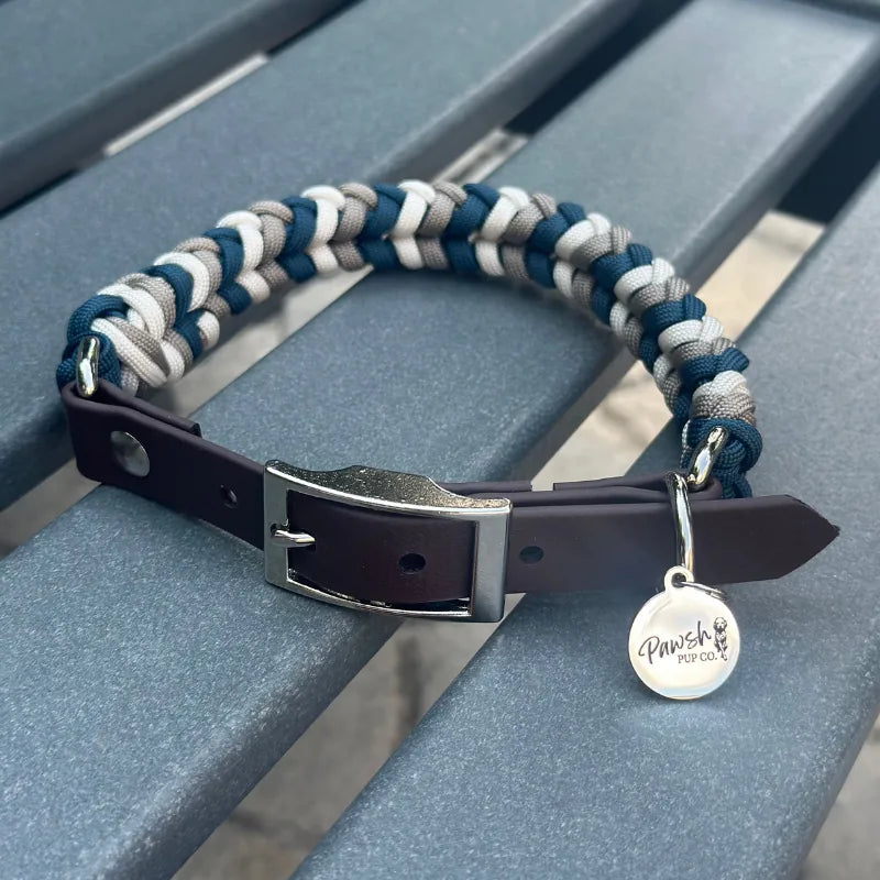Hand-braided dog collar in navy, tan, and cream with a dark brown adjustable strap and nickel plated buckle.