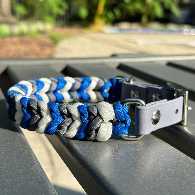 Hand-braided dog collar in royal blue, graphite, and white, featuring an adjustable gray strap and nickel-plated buckle.